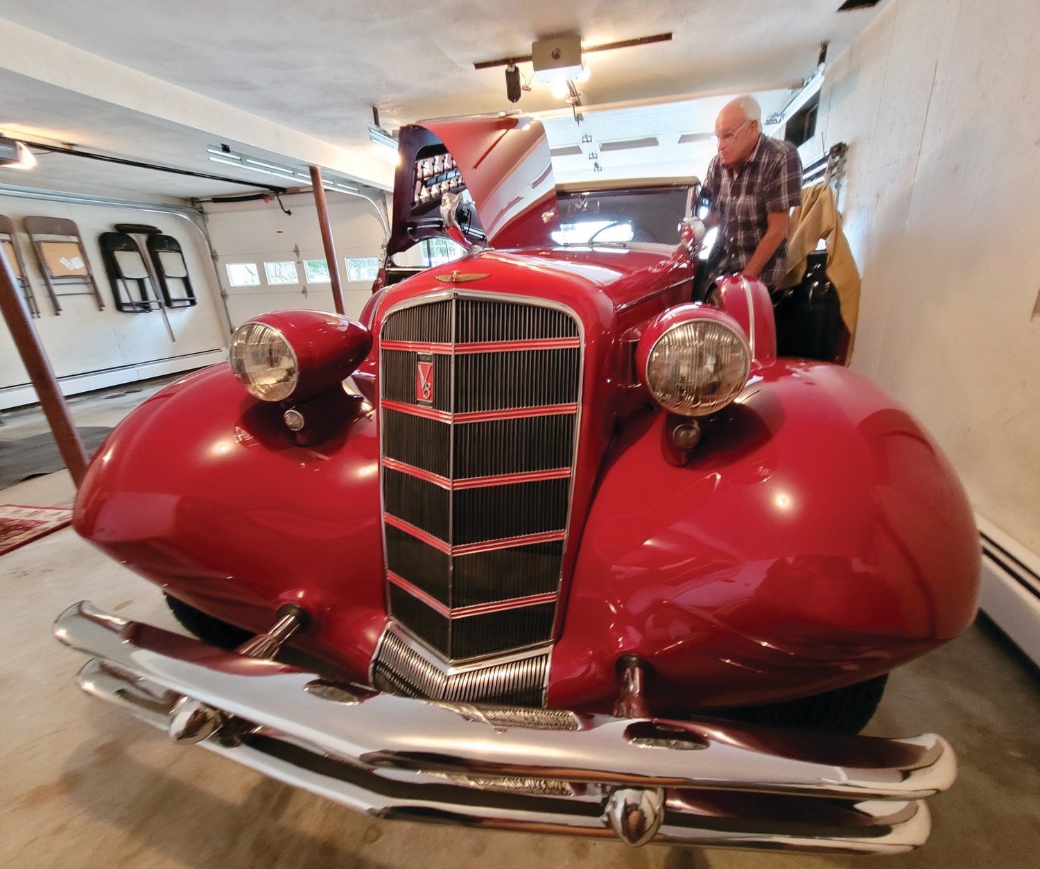 READY TO ROLL: John Ricci opened the suicide doors and climbed into his 1934 Cadillac.